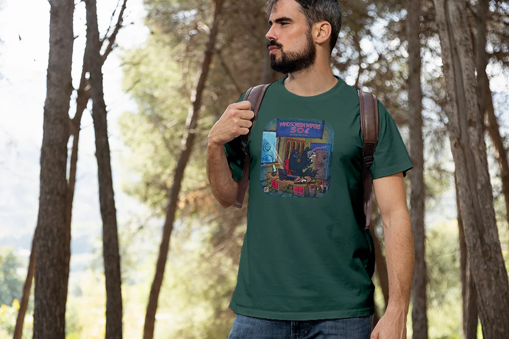 Man in a forest wearing T-shirt with George the Crow