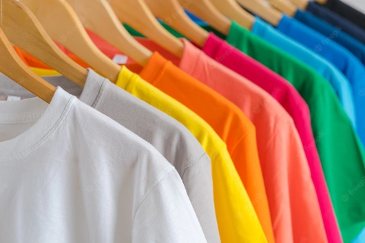 Close up of colorful t-shirts on hangers